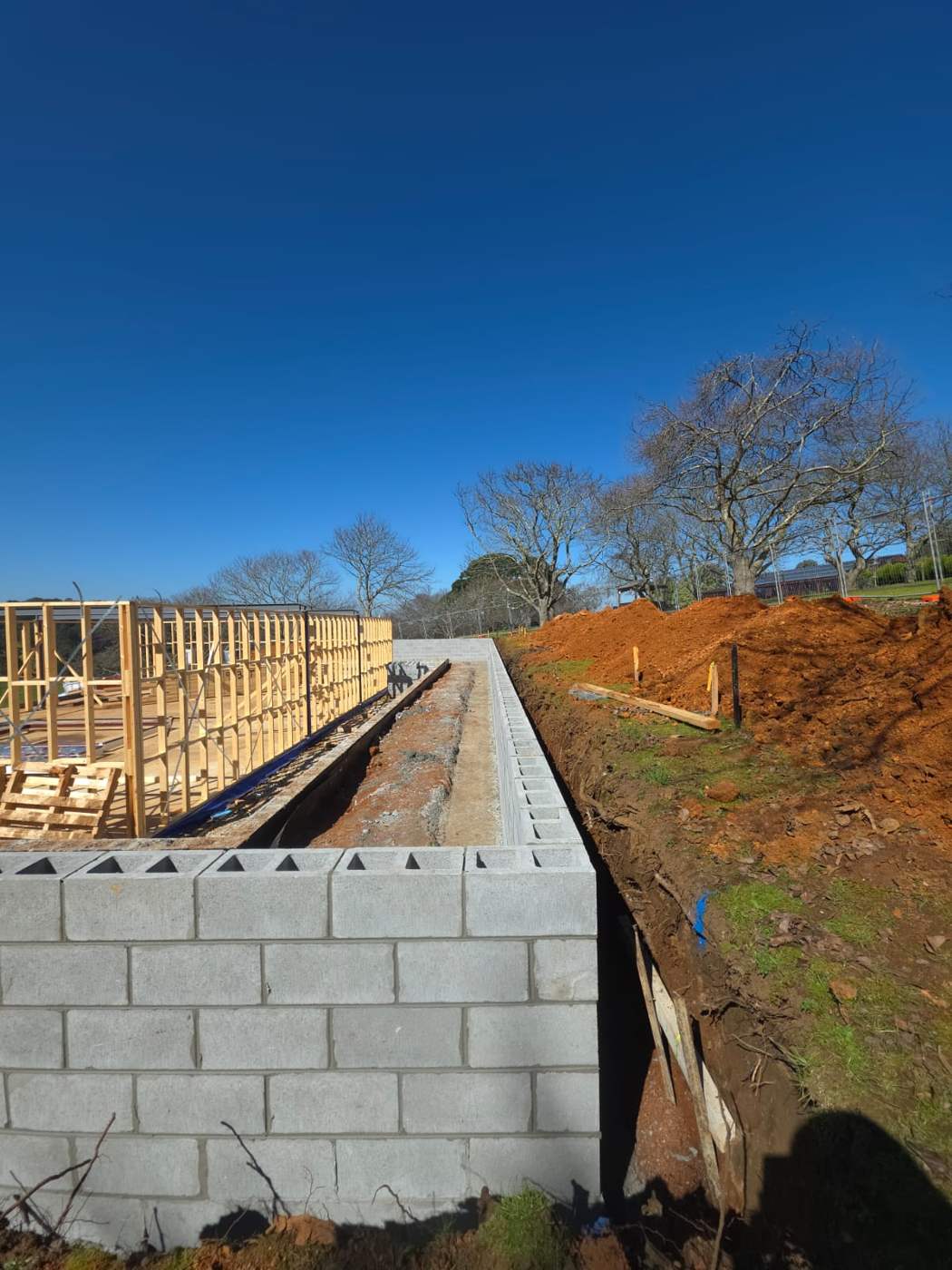 Block retaining wall built against a cut batter with timber shoring and drainage, block retaining walls, Melbourne