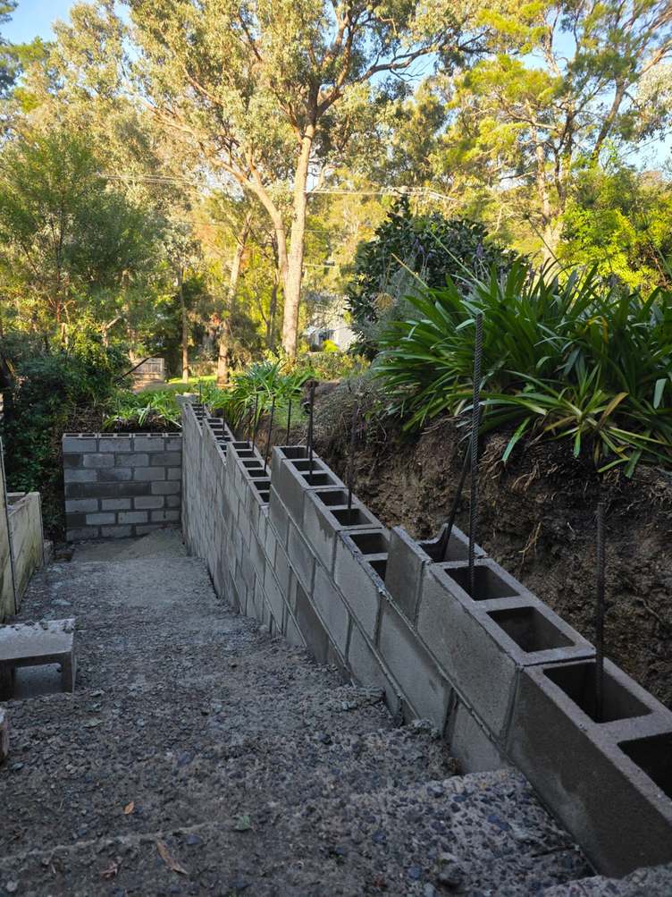Block retaining wall with open cores and drainage gravel on a garden bank, block retaining walls, Melbourne