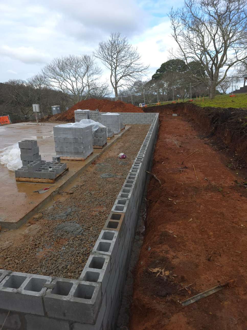 Long block retaining wall under construction against a clay cut, block retaining walls, Melbourne