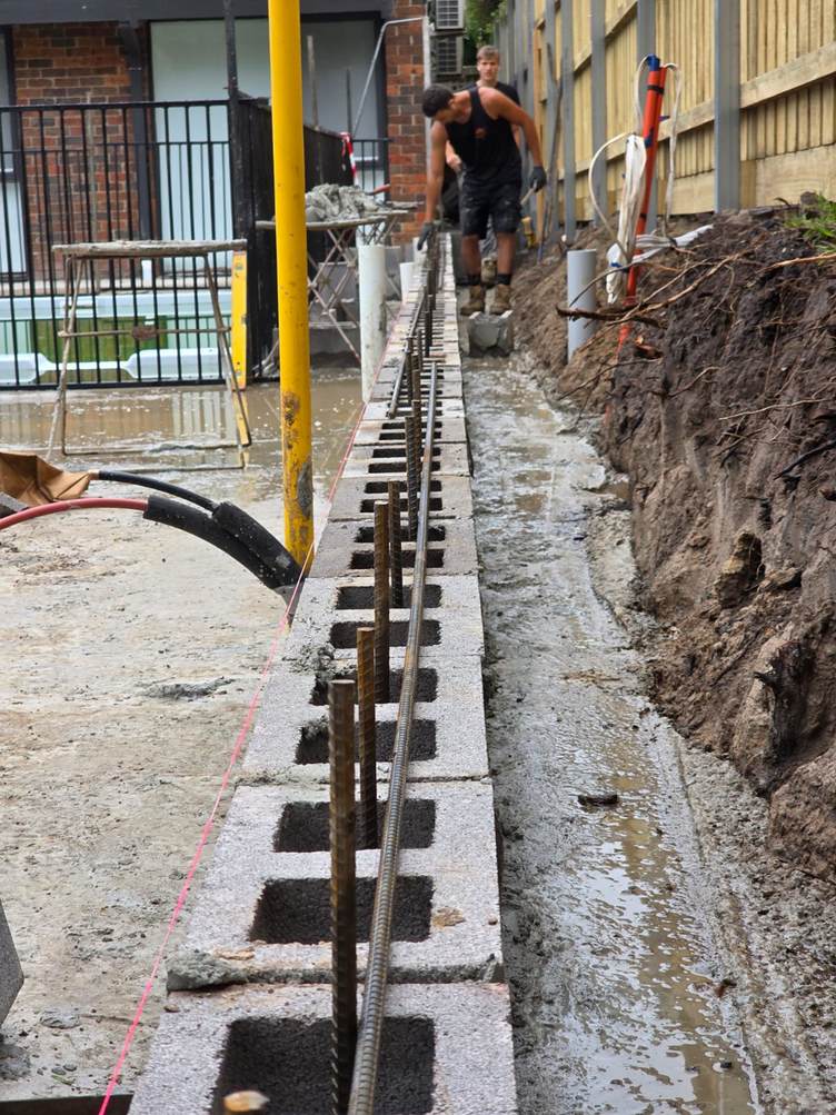 Core-filled block wall with vertical steel reinforcement and ag drain, reinforced blockwork, Melbourne