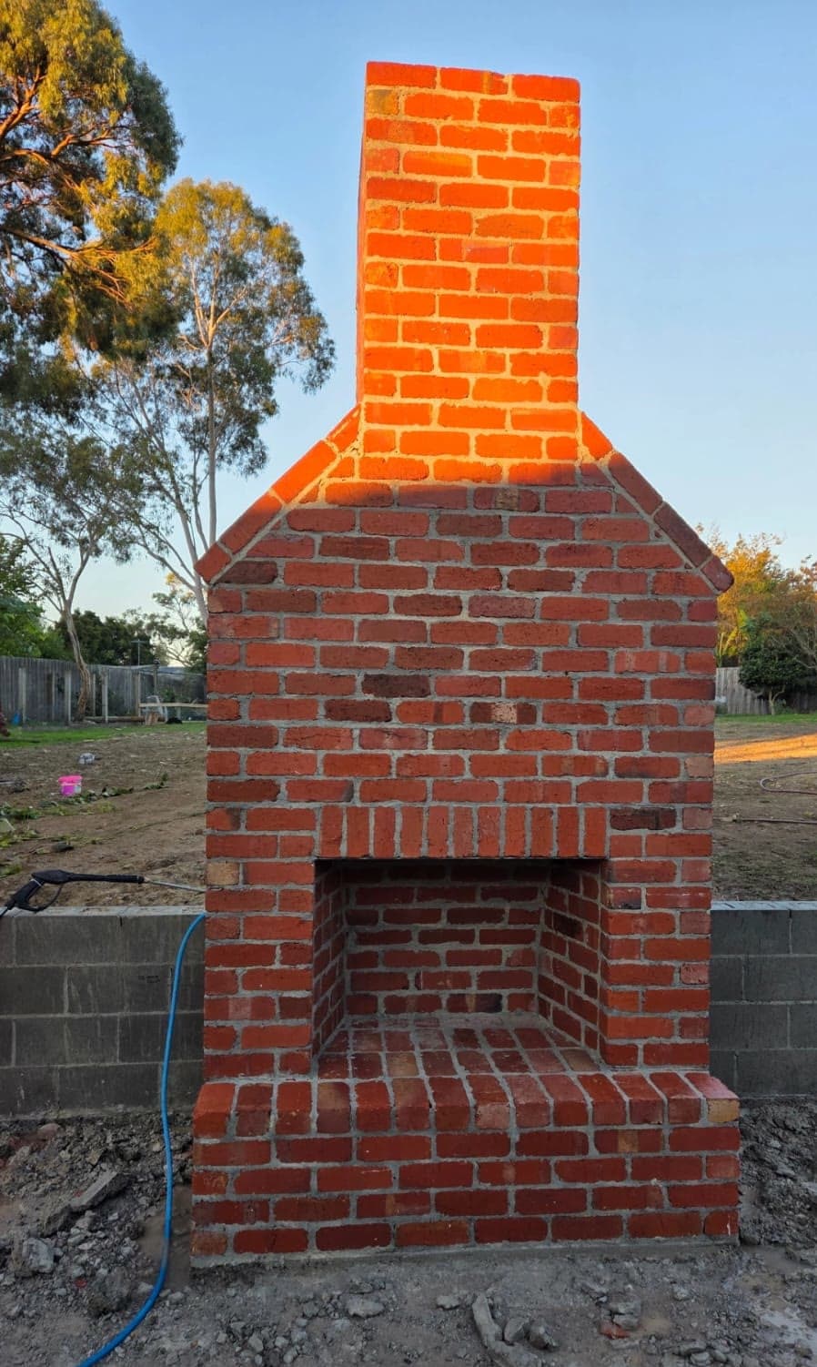 custom outdoor brick fireplace built in a backyard — JC Brick & Blocklaying — bricklayer Melbourne eastern suburbs