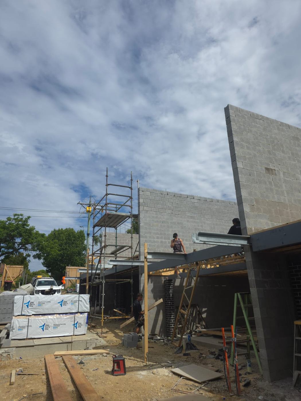 Blocklayer on scaffolding building a large structural block wall, structural blockwork, Melbourne